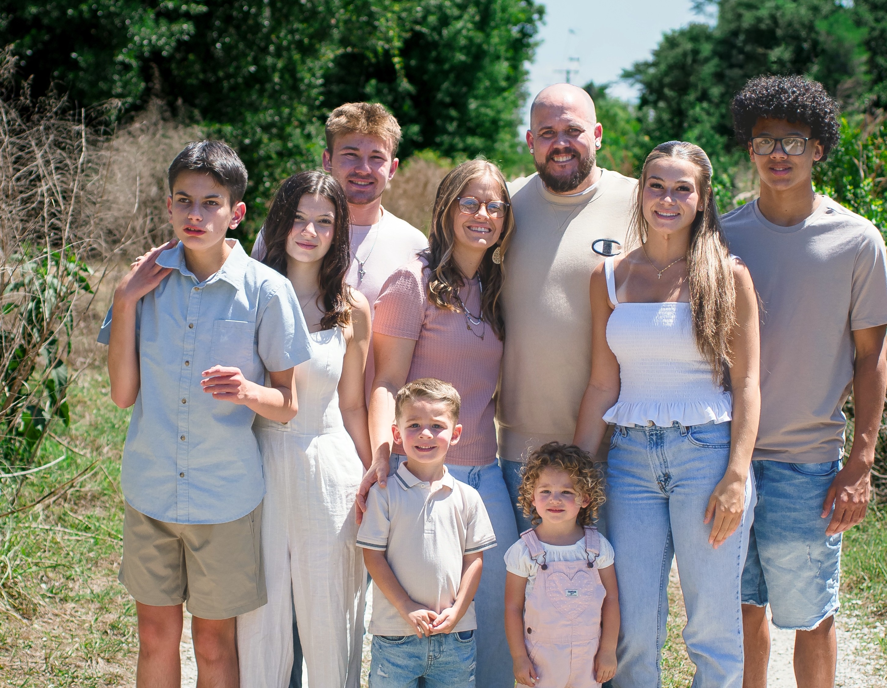 A foster family gathered together outdoors